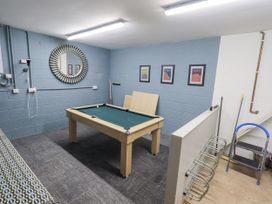 A games room with a pool table and framed pictures at No 7 in Ambleside
