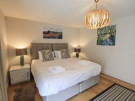 A bedroom with a double bed and decorative lights at No 7 Ambleside