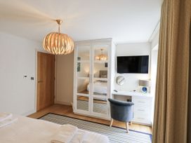 A bedroom with a wardrobe and television at No 7 in Ambleside