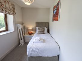 A bedroom with a single bed and a lamp at No 7 in Ambleside