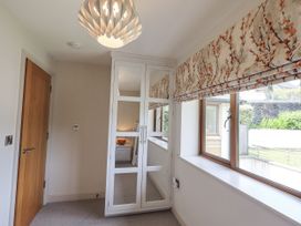 A bedroom with a mirror cabinet and window at No 7 in Ambleside
