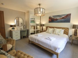 A bedroom with a bed and seating area at No 7 in Ambleside