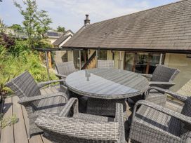 An outdoor seating area with a circular table and chairs at No 7 in Ambleside
