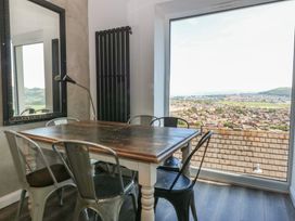 A dining room with a table and chairs at Sea View in Llandudno