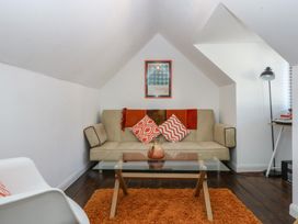 A living room with a sofa and coffee table at Sea View in Llandudno