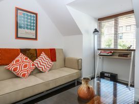 A living room with a sofa and a desk at Sea View in Llandudno
