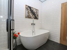 A bathroom with a bathtub and shower at Sea View in Llandudno