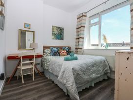 A bedroom with a bed and desk at Sea View in Llandudno