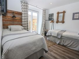 A bedroom with two beds and a window at Sea View in Llandudno
