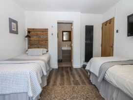 A bedroom with two beds and an adjoining bathroom at Sea View in Llandudno