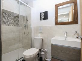 A bathroom with a shower, toilet, and sink at Sea View in Llandudno