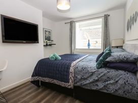 A bedroom with a bed and television at Sea View in Llandudno