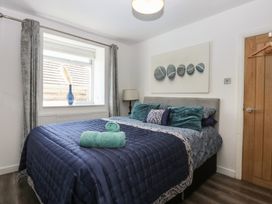 A bedroom with a bed and window at Sea View in Llandudno