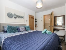 A bedroom with a bed and towels at Sea View in Llandudno
