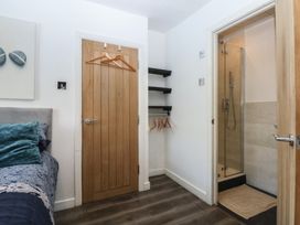 A bedroom with a bed and a shower stall at Sea View in Llandudno