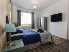 A bedroom with a bed and television at Sea View in Llandudno