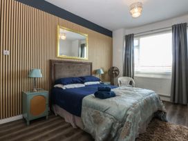 A bedroom with a bed and dresser at Sea View in Llandudno