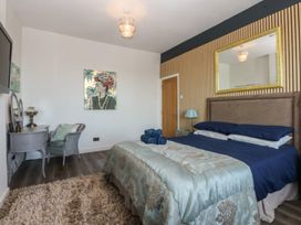 A bedroom with a bed and decorative items at Sea View Llandudno