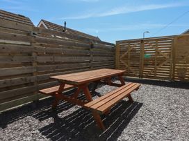An outdoor area with a picnic table and wooden fence at Sea View in Llandudno