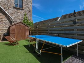 A garden with a table tennis table and shed at Sea View in Llandudno