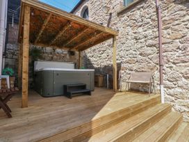 An outdoor area with a hot tub and wooden seating at Sea View in Llandudno