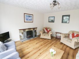 A living room with a fireplace and seating arrangements at Brow O' The Hill in Ballyshannon