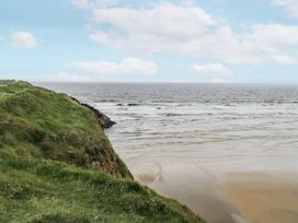 A coastal view with grass and sand at Brow O' The Hill in Ballyshannon