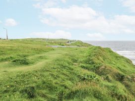 A coastal view with grass and a road at Brow O' The Hill in Ballyshannon