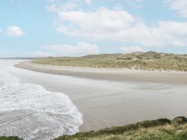 A beach scene with waves and sand dunes at Brow O' The Hill in Ballyshannon