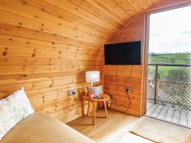 A small living area with a sofa and table at The Rhiw in Llanfair Caereinion