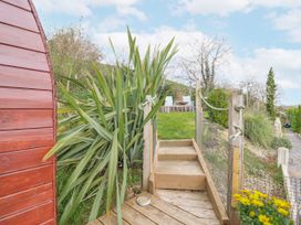 A garden with wooden steps and outdoor seating area at The Rhiw in Llanfair Caereinion