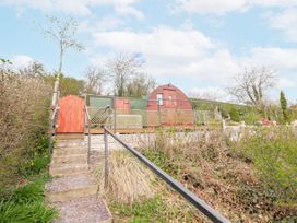 An outdoor view of a wooden shed with steps leading up to it at The Rhiw in Llanfair Caereinion