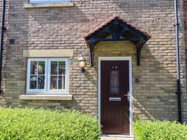 An entrance with a door and window at Driftwood in Filey
