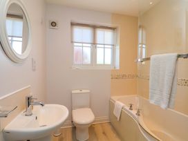 A bathroom with sink and bath tub at Driftwood in Filey