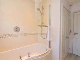 A bathroom with a bathtub and shower at Driftwood in Filey