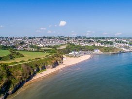 An aerial view of a beach and houses in Benllech