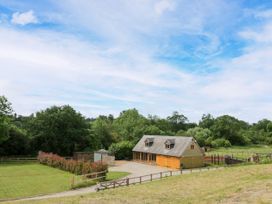 A house with trees and a driveway at The Coach House in Chacombe