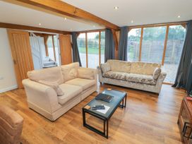 A living room with two sofas and a coffee table at The Coach House in Chacombe