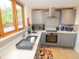 A kitchen with a sink and appliances at The Coach House in Chacombe