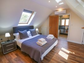 A bedroom with a bed and ensuite bathroom at The Coach House in Chacombe