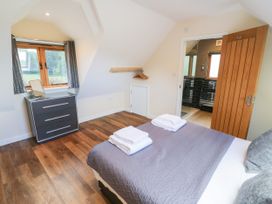 A bedroom with a bed and drawers at The Coach House in Chacombe