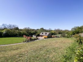 A house with a garden area and trees at The Coach House in Chacombe