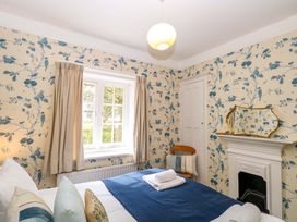 A bedroom with a bed and a window at Beckhythe Cottage Overstrand