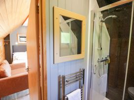 A bathroom with a shower and towel rail at Acorn Lodge At Bridge Lake Farm & Fishery, Chacombe