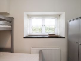A bedroom with a bunk bed and window at Pen Y Cefn