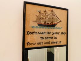 A framed artwork featuring a ship and a quote at Pen Y Cefn in Pen Y Cefn