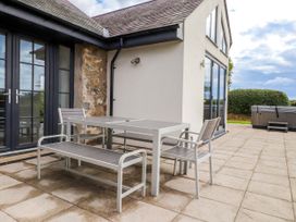 An outdoor area with a table and chairs at Pen Y Cefn