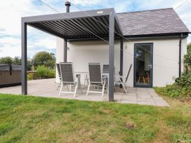 An outdoor seating area with a table and chairs at Pen Y Cefn