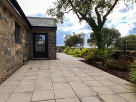 An outdoor area with a stone wall and plants at Pen Y Cefn in Pen Y Cefn