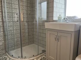 A bathroom with a shower and sink at The Stables At Cae Gwyn in Ruthin